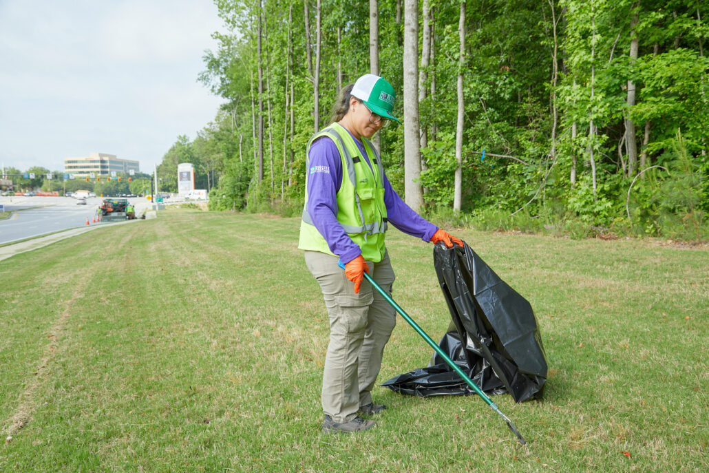 Landscaper picking up trash