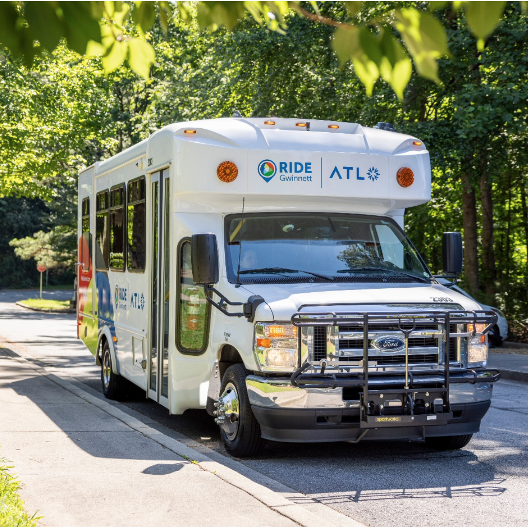 A Ride Gwinnett microtransit bus waits for passengers